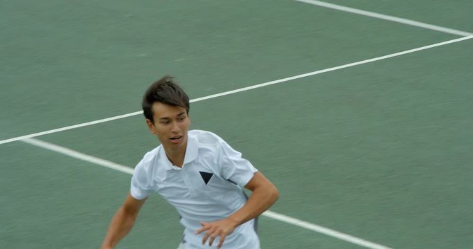 A mixed race tennis player runs across court, stretches to volley a shot and celebrates being number one.