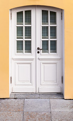 Obraz na płótnie Canvas Classic white wooden door with small windows