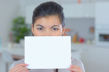 woman holding white paper sheet