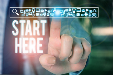 Conceptual hand writing showing Start Here. Concept meaning telling someone this is beginning point to go from to destination Woman wear work suit presenting presentation smart device