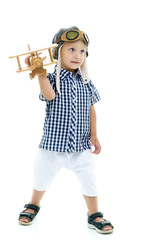 Little boy playing with wooden plane