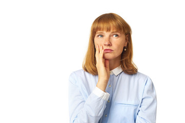 Indoor shot of nice redhead young woman looking sideways, having doubtful and indecisive face...