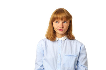 Indoor shot of nice redhead young woman looking sideways, having doubtful and indecisive face...