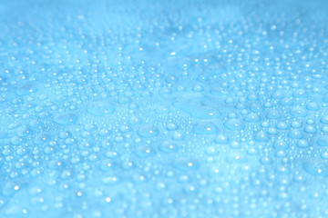 Naklejka na ściany i meble Close up water drops on blue background, Water drop in macro photography