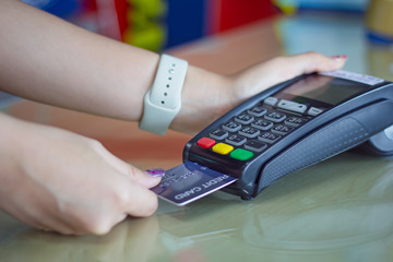 Young woman paying by credit card.