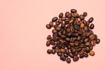 Coffee beans on a pink background.