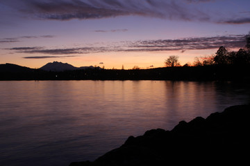 twilight by the lake in Cham, Zug with the swiss alps