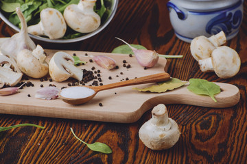 composition poured olive oil, mushrooms, garlic on wooden background