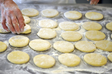 Italy, chef making industrial pizza