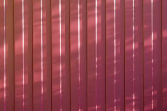 red metal fence on a Sunny day