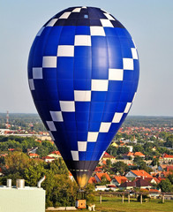 Hot air balloon in the air over the city