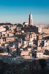 Fototapeta premium Matera, Italy - August 2019: View of the ancient city of Matera from the Belvedere of Murgia Timone, at the dawn of a day in August 