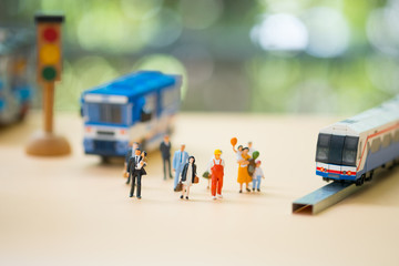 Obraz premium Miniature people: Traffic within the capital between people and public bus or train