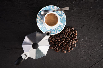 cup of coffee and beans on grey surface