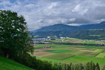 Mountains are covered in clouds over the city of Innsbruck in the Austrian Alps on a cloudy day. Surroundings of the city of Innsbruck.