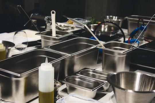 Stainless steel cooking containers in a professional kitchen