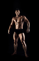 Fototapeta na wymiar portrait muscular man on black background