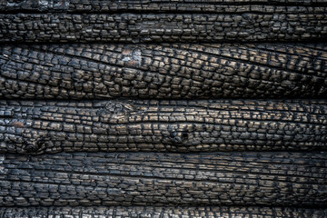 close up of a charred wall of a blockhouse