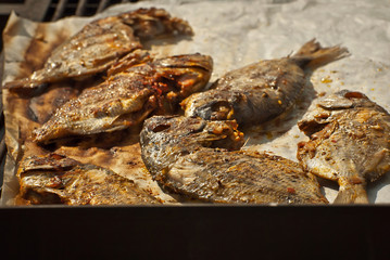 Fried seafood on the table. Many varieties of seafood at the festival. Fried fish.