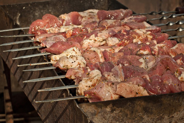 Barbecue fries in the coals. Meat and beef at the field kitchen festival.