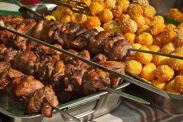 Barbecue fries in the coals. Meat and beef at the field kitchen festival.