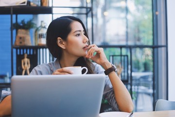 Fototapeta premium young woman with laptop in cafe