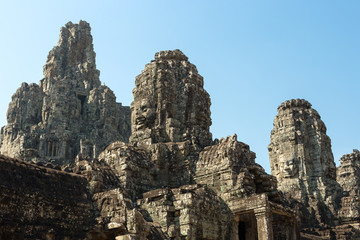 Faces carved in stone in Bayon temple towers, Angkor Wat complex, Cambodia, Siem Reap