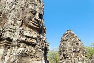 Faces carved in stone in Bayon temple towers, Angkor Wat complex, Cambodia, Siem Reap