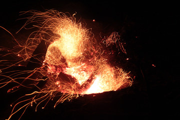 Bonfire close-up shot on a long exposure on a dark background.