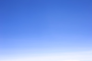 blue sky with white, soft clouds background.