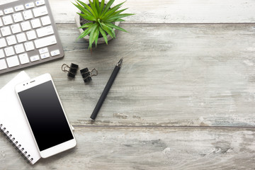 White desk office with laptop, smartphone and other work supplies with cup of coffee. Top view with copy space for input the text. Designer workspace on desk table essential elements on flat lay