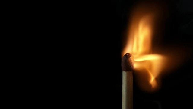 Super slow motion of striking matches, macro view, black background. Filmed on high speed cinema camera, 1000fps.
