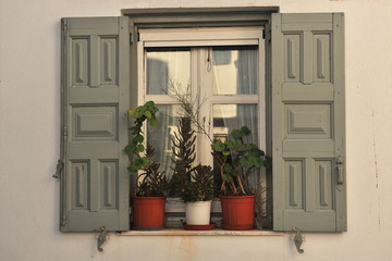 Window with shutters of a small residential building.