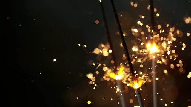 Super slow motion of burning sparklers on black background. Filmed on high speed cinema camera, 1000fps.