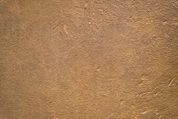 Blurred golden brown plaster wall. Backgrounds and textures
