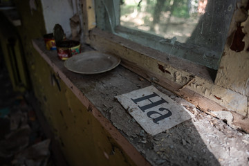 Phonetic cue cards on window sill of abandoned building