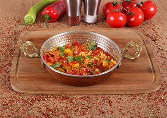 Egg and tomato omelette for breakfast in a copper dish