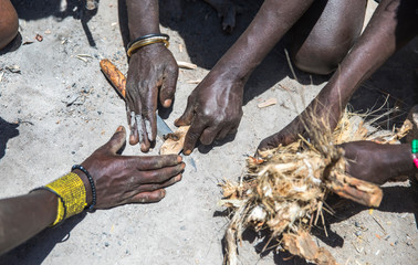 Hadzabe men making fire
