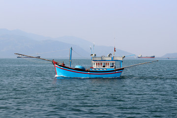 Naklejka na ściany i meble small fishing boat in the sea