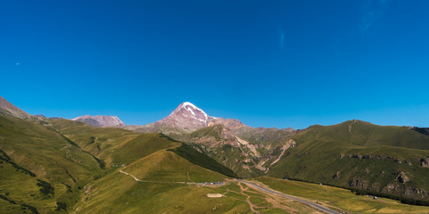 Caucasus Mountains on the border of Russia and Georgia. Very beautiful view of the Mount Kazbek, the second highest peak in Georgia with background of cloud.