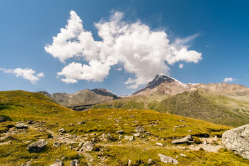 Caucasus Mountains on the border of Russia and Georgia. Very beautiful view of the Mount Kazbek, the second highest peak in Georgia with background of cloud.
