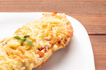 Bruschetta with tomatoes, mozzarella cheese and basil on a wooden background. Traditional italian appetizer or snack, antipasto. Isolated