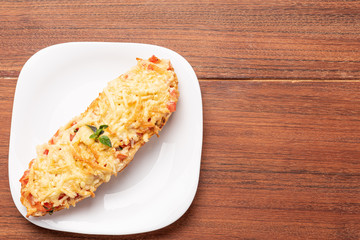 Bruschetta with tomatoes, mozzarella cheese and basil on a wooden background. Traditional italian appetizer or snack, antipasto. Isolated