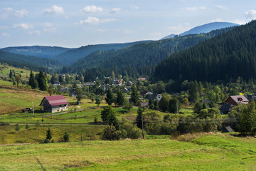 Fototapeta premium Houses Mountains in spring time. Carpathian Mountains