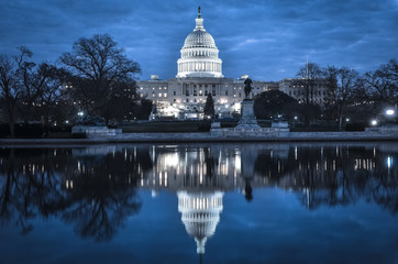 United States Capitol Building and its water reflection in the night - Washington D.C. United States of America