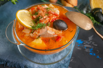 Seafood soup, salmon and cod with potatoes. National soup of French fishermen. Served with lemon and olives