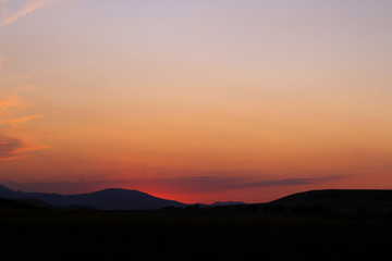 Mountains silhouette and sunset sunbeams. 