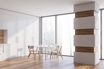 Panoramic white kitchen with column and table