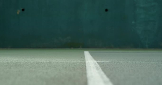 Close up of a tennis player serving.