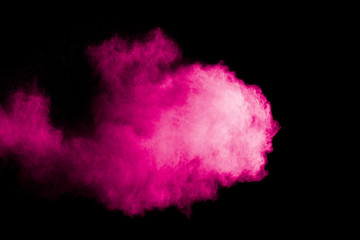 Pink powder explosion cloud on black background.